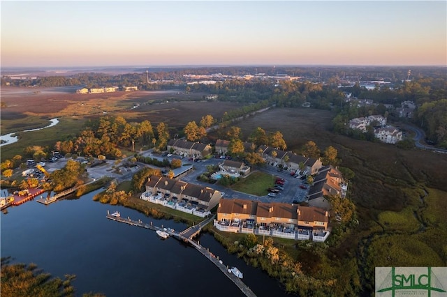 aerial view at dusk with a water view