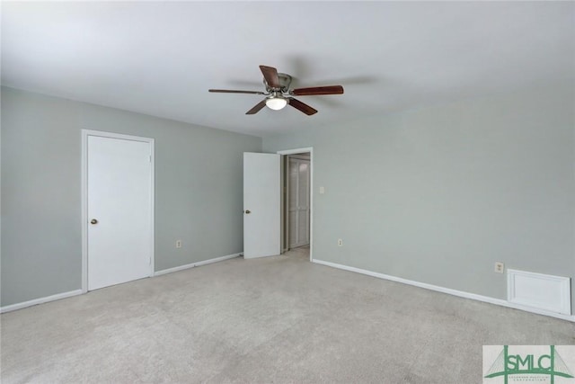 carpeted spare room featuring ceiling fan