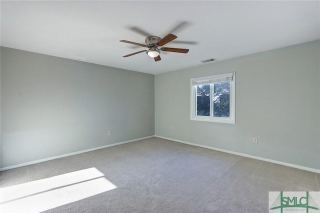 carpeted spare room with ceiling fan