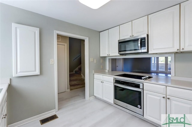 kitchen featuring appliances with stainless steel finishes and white cabinets