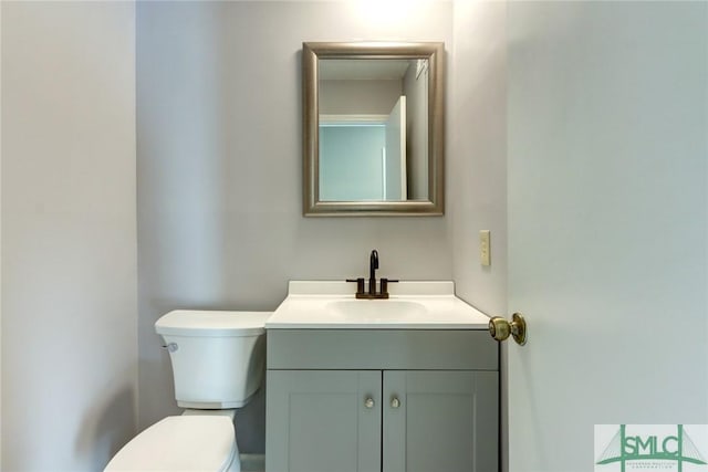 bathroom with toilet and vanity