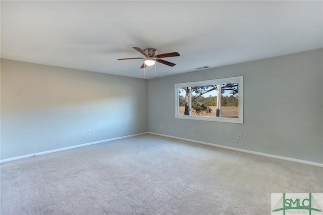 carpeted empty room featuring ceiling fan