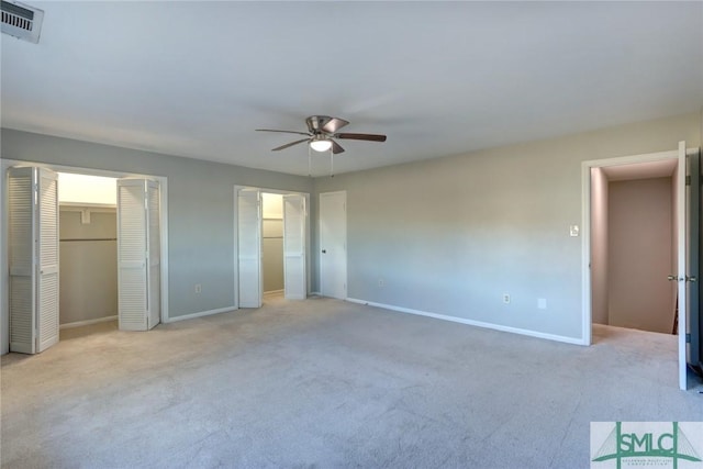 unfurnished bedroom with ceiling fan and light colored carpet