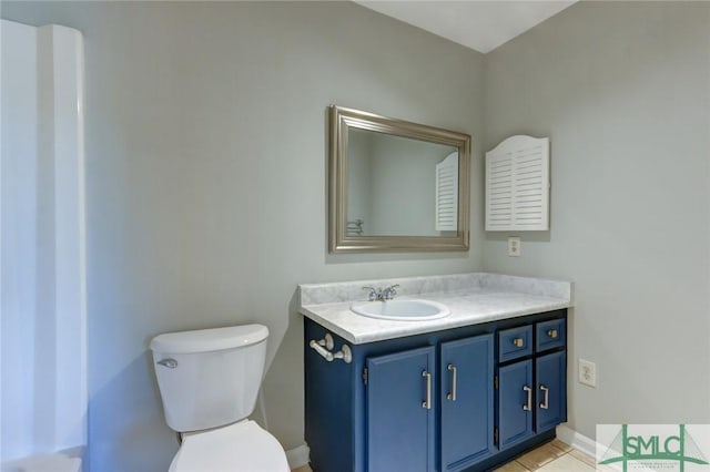 bathroom featuring toilet, vanity, and tile patterned floors