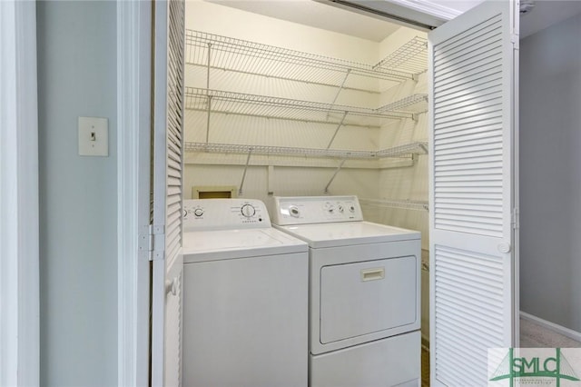 clothes washing area with light colored carpet and washing machine and clothes dryer