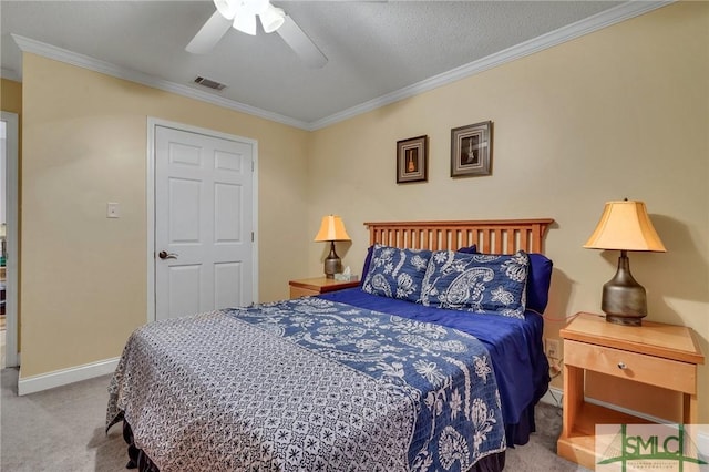 carpeted bedroom with ceiling fan and ornamental molding