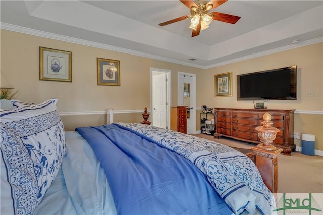 bedroom with ceiling fan, ornamental molding, carpet, and a raised ceiling