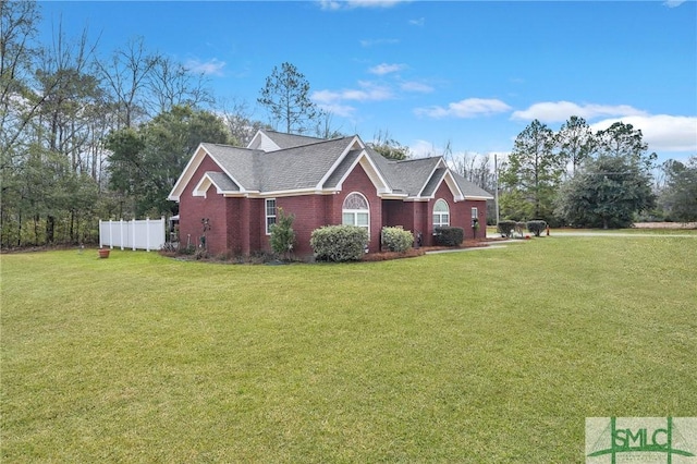 view of side of property with a lawn