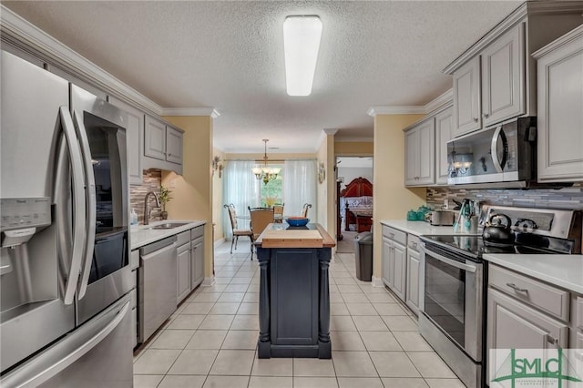 kitchen with sink, wood counters, gray cabinetry, and stainless steel appliances