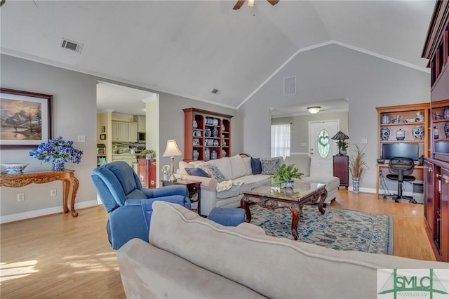 living room with light hardwood / wood-style floors, lofted ceiling, and ceiling fan