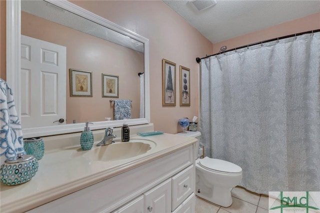 bathroom featuring a textured ceiling, toilet, vanity, and tile patterned flooring