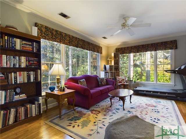 sitting room featuring ceiling fan, ornamental molding, and light hardwood / wood-style floors