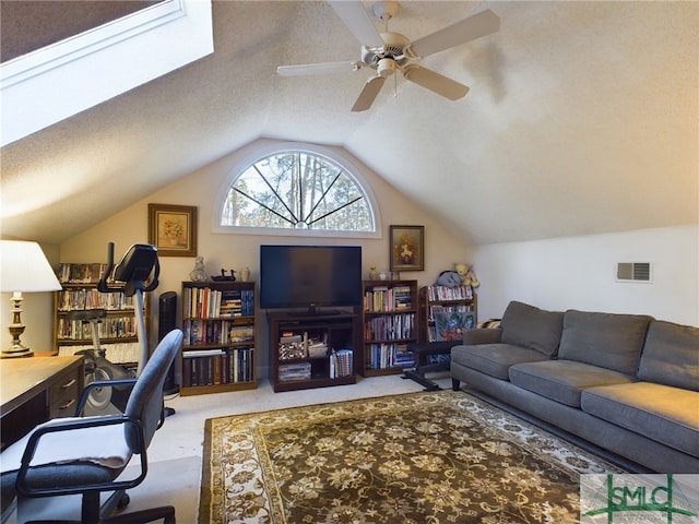 office area featuring light carpet, ceiling fan, a textured ceiling, and lofted ceiling