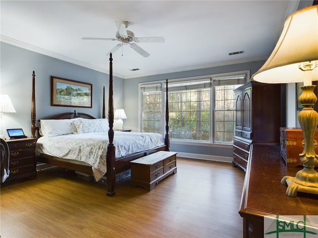 bedroom featuring ceiling fan, dark hardwood / wood-style flooring, and ornamental molding