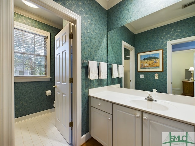 bathroom with tile patterned floors, toilet, vanity, and crown molding