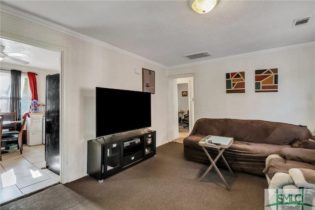 carpeted living room featuring ceiling fan, a textured ceiling, and ornamental molding