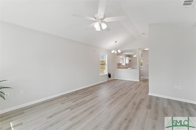 unfurnished living room featuring vaulted ceiling, ceiling fan with notable chandelier, and light hardwood / wood-style flooring