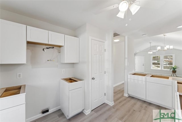 kitchen with pendant lighting, white cabinets, light hardwood / wood-style floors, vaulted ceiling, and ceiling fan