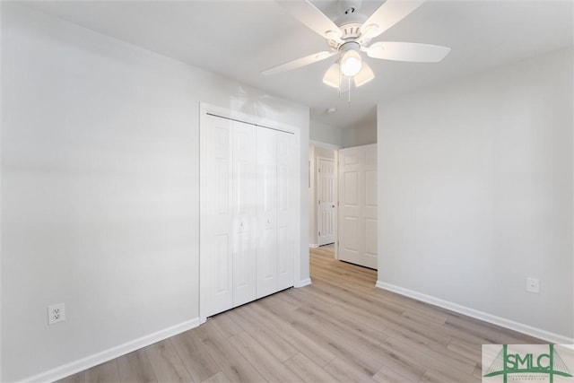 unfurnished bedroom featuring a closet, ceiling fan, and light wood-type flooring