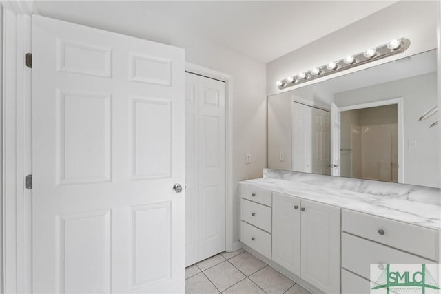 bathroom featuring tile patterned flooring and vanity