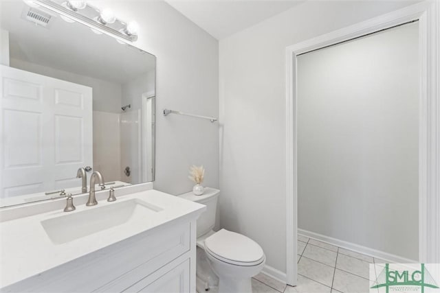 bathroom featuring vanity, toilet, tile patterned flooring, and a shower