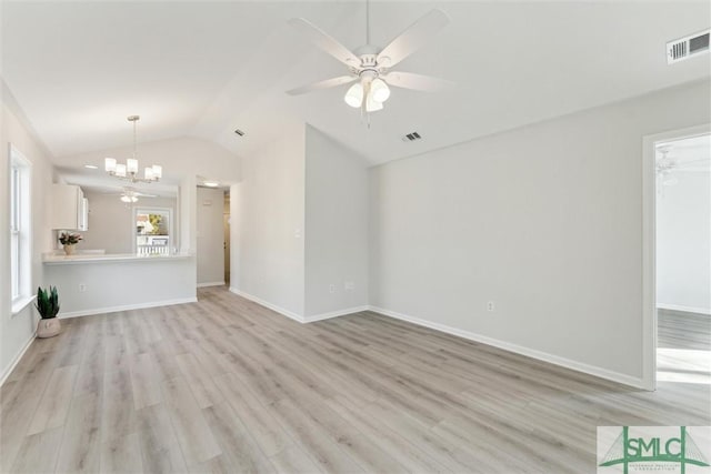 unfurnished living room featuring ceiling fan with notable chandelier, lofted ceiling, and light hardwood / wood-style floors