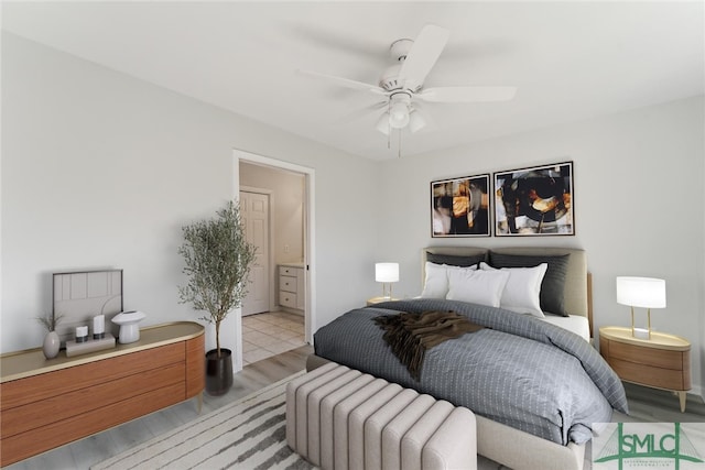 bedroom with ceiling fan, connected bathroom, and light wood-type flooring