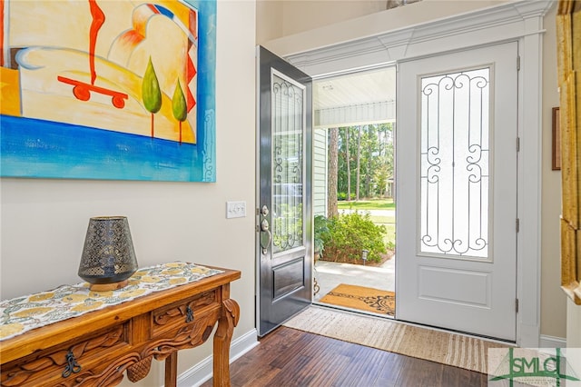 entryway with wood finished floors and baseboards