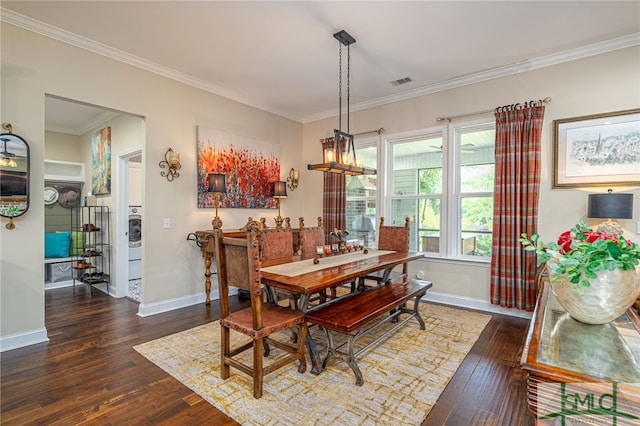 dining room featuring dark hardwood / wood-style flooring and crown molding