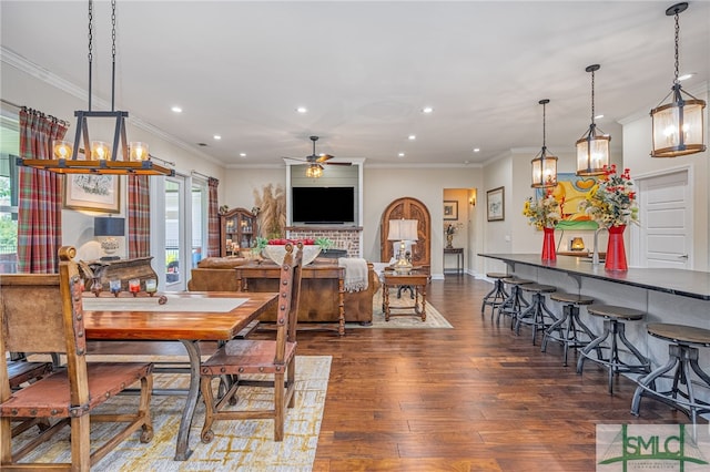 dining space featuring ceiling fan, crown molding, and dark hardwood / wood-style floors