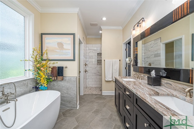 bathroom with plus walk in shower, tile walls, tile patterned floors, crown molding, and vanity