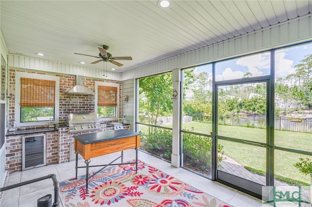 sunroom featuring ceiling fan and wine cooler