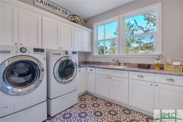 laundry room featuring sink, separate washer and dryer, and cabinets