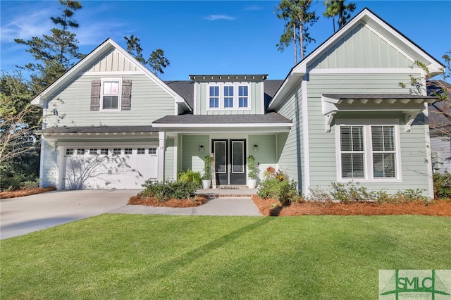 view of front of property with driveway, a garage, a front lawn, and board and batten siding