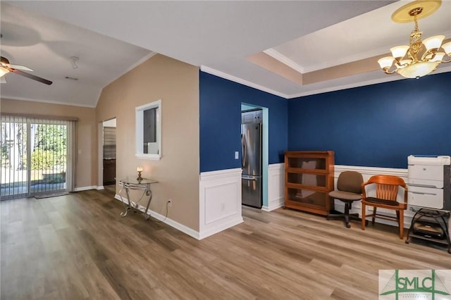 sitting room featuring hardwood / wood-style flooring, crown molding, and ceiling fan with notable chandelier