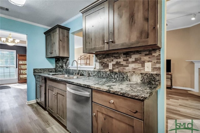 kitchen with dark stone countertops, sink, backsplash, light wood-type flooring, and stainless steel dishwasher