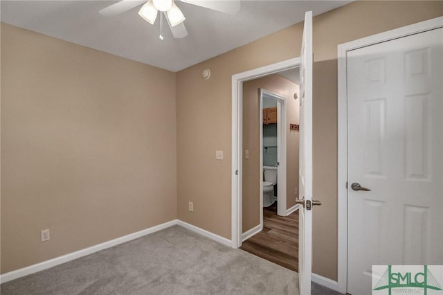 carpeted empty room featuring ceiling fan