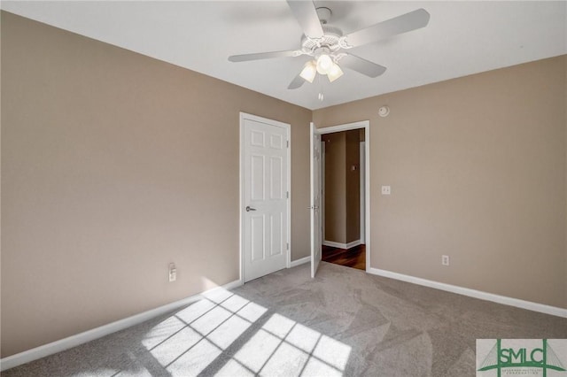 unfurnished bedroom featuring ceiling fan and light colored carpet