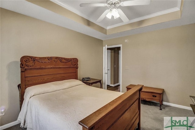 bedroom featuring light carpet, ceiling fan, crown molding, and a tray ceiling