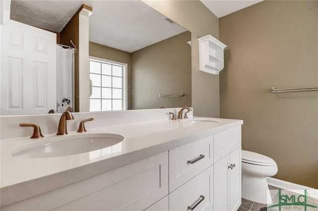 bathroom featuring tile patterned floors, toilet, and vanity