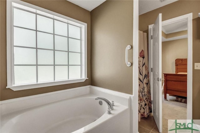 bathroom with a wealth of natural light, tile patterned floors, and independent shower and bath
