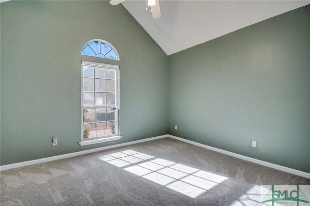 unfurnished room with high vaulted ceiling, plenty of natural light, carpet, and ceiling fan