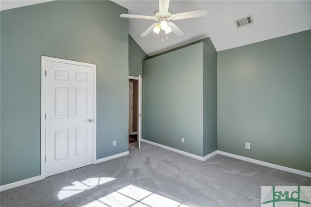 unfurnished bedroom with ceiling fan, light colored carpet, and high vaulted ceiling