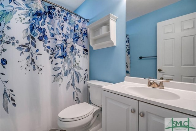 bathroom featuring toilet, vanity, and a shower with curtain