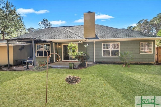 back of property with a patio area and a lawn