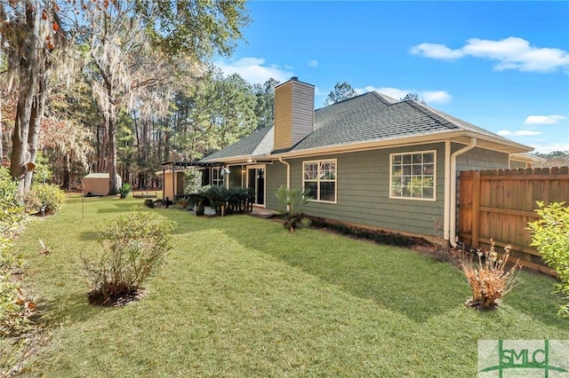 back of property featuring a yard