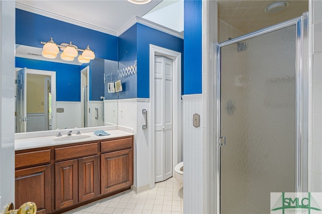 bathroom featuring a shower with shower door, toilet, vanity, and crown molding