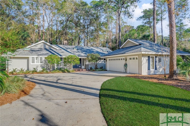 single story home featuring a garage and a front lawn