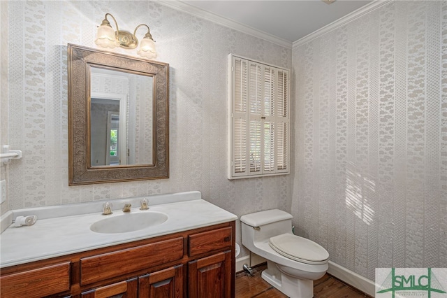 bathroom featuring toilet, crown molding, hardwood / wood-style floors, and vanity