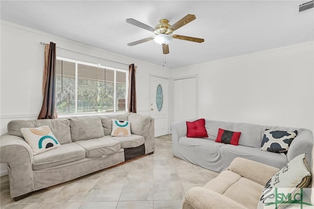 living room with ceiling fan and ornamental molding